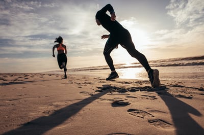 Couple exercising on the beach through jogging